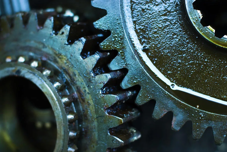 close-up of gear teeth with a visible oil film